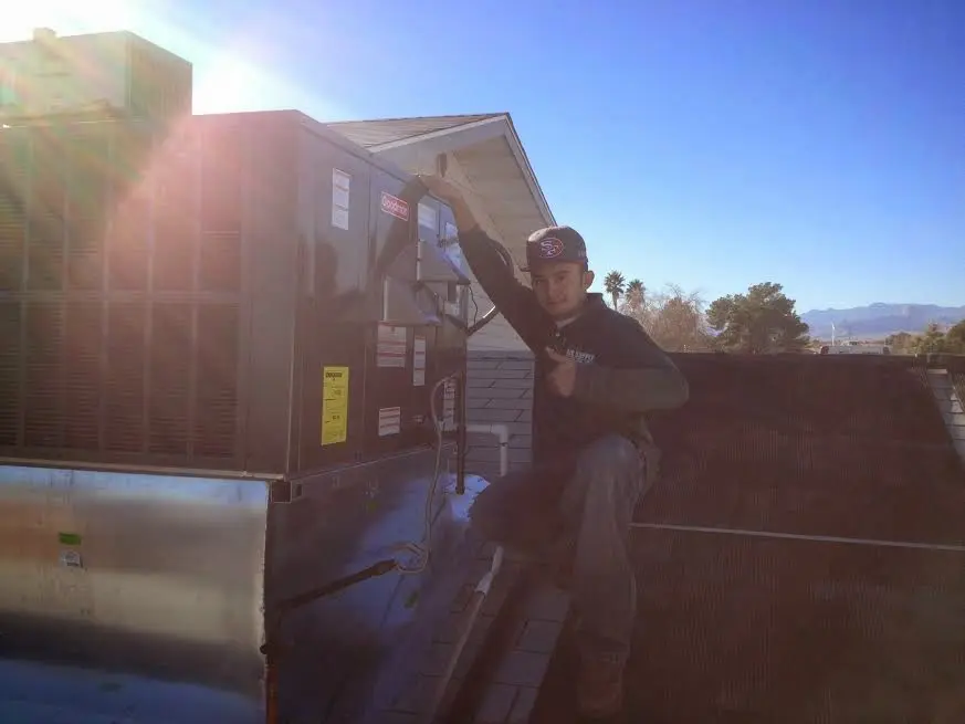 HVAC technician performing Air Duct Repair on a rooftop unit in Columbia